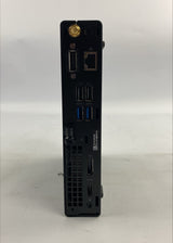A black desktop mini computer shown from the rear, displaying various ports including USB, Ethernet, and blue USB 3.0 ports, set against a plain white background.